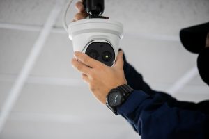 technician installing a wireless security system camera